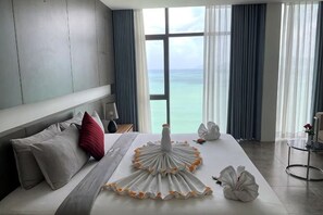 Une chambre d’hôtel avec un grand lit, une vue sur la mer et un design moderne.