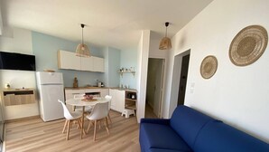 A compact living space with a kitchenette, a dining area, and a seating area.