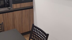 A modern kitchen with a microwave, oven, and a flat-screen TV mounted on the wall. - Little paradise in the heart of Castel di Sangro (Castel di Sangro)