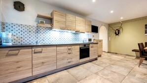 A modern kitchen with wooden cabinets, a microwave, and a sink.