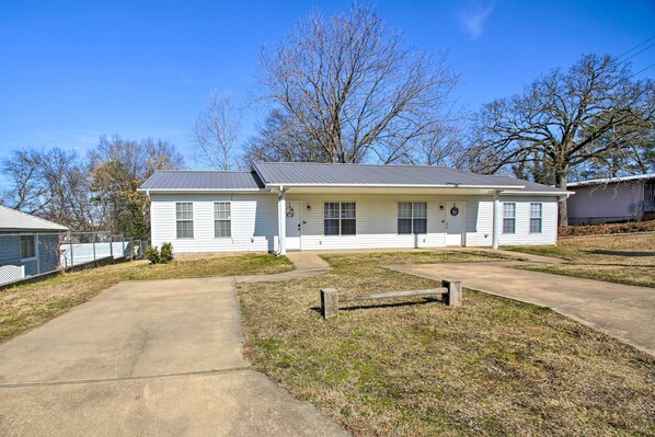 A single-story house with a front porch, a garage, and a fenced yard. - Perfect Getaway for the family with touches of home (Hot Springs)