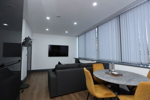Apartment | Living area | 70-inch Smart TV with cable channels, TV, Netflix