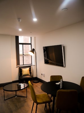 Apartment | Living area | 70-inch Smart TV with cable channels, TV, Netflix