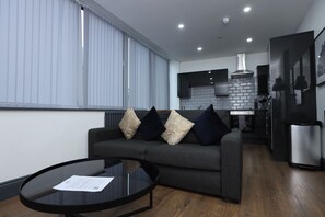 Apartment | Living area | 70-inch Smart TV with cable channels, TV, Netflix - New Oxford House Apartments (Liverpool)