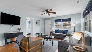 A living room with a flat-screen TV, ceiling fan, sofa, coffee table, and a lamp. - Lovely 3Br House,Beach Access,Sm Dogs,V384 (North Myrtle Beach)