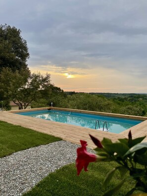 Seasonal outdoor pool, open 9:00 AM to 8:00 PM, pool loungers