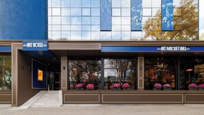 The Art Hotel facade with a modern design, large windows, and a signboard. - Art Hotel (Chisinau)