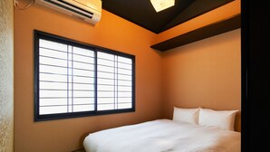 A hotel room with a large window, a bed, and a ceiling fan. - TSUBOMI luxury Inn shimabara-bettei 3 (Kyoto)