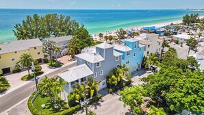 A coastal residential area with buildings, a beach, and clear skies. - Sunset Point - Dreamy Beach House, Hot Tub, Roof Top Deck, Great Location! (Treasure Island)