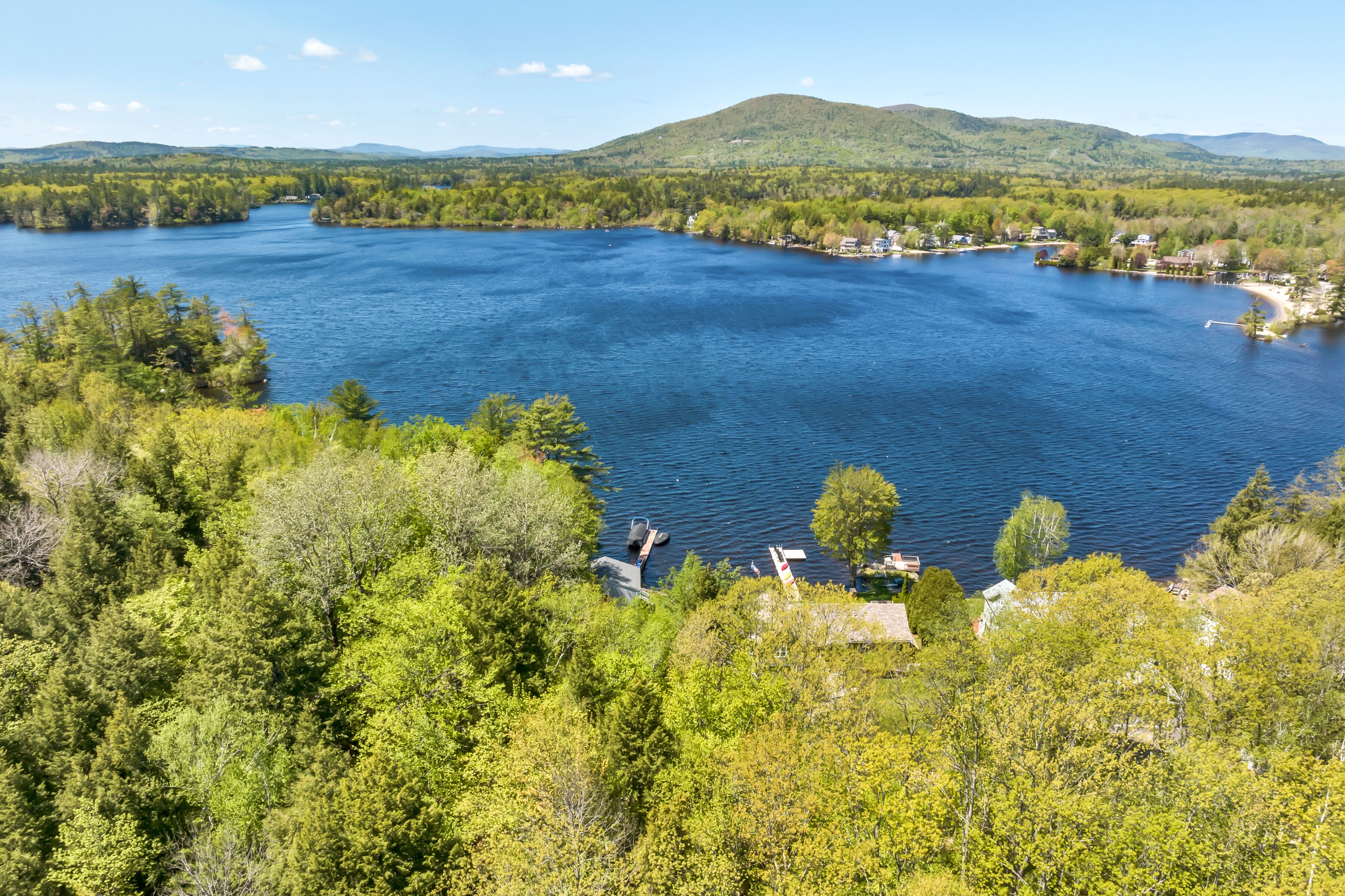 A lake surrounded by dense forest and hills.