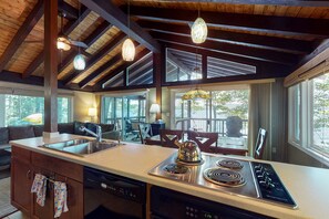 Enjoy cooking in this well-equipped kitchen with a central island, stovetop, and double sink.
