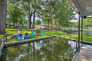 Escape to a serene lakeside retreat surrounded by lush greenery and mature trees, perfect for kayaking and paddleboarding.