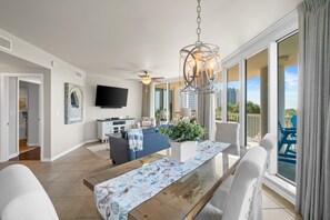 Relax in this stylish living area with a dining table for four, flat-screen TV, and comfortable sofa.
