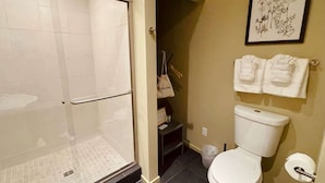 A bathroom with a glass-enclosed shower, a toilet, and a sink. - #2 Alder Queen Room - Fireplace in Olympic Nat'l Pk (Port Angeles)