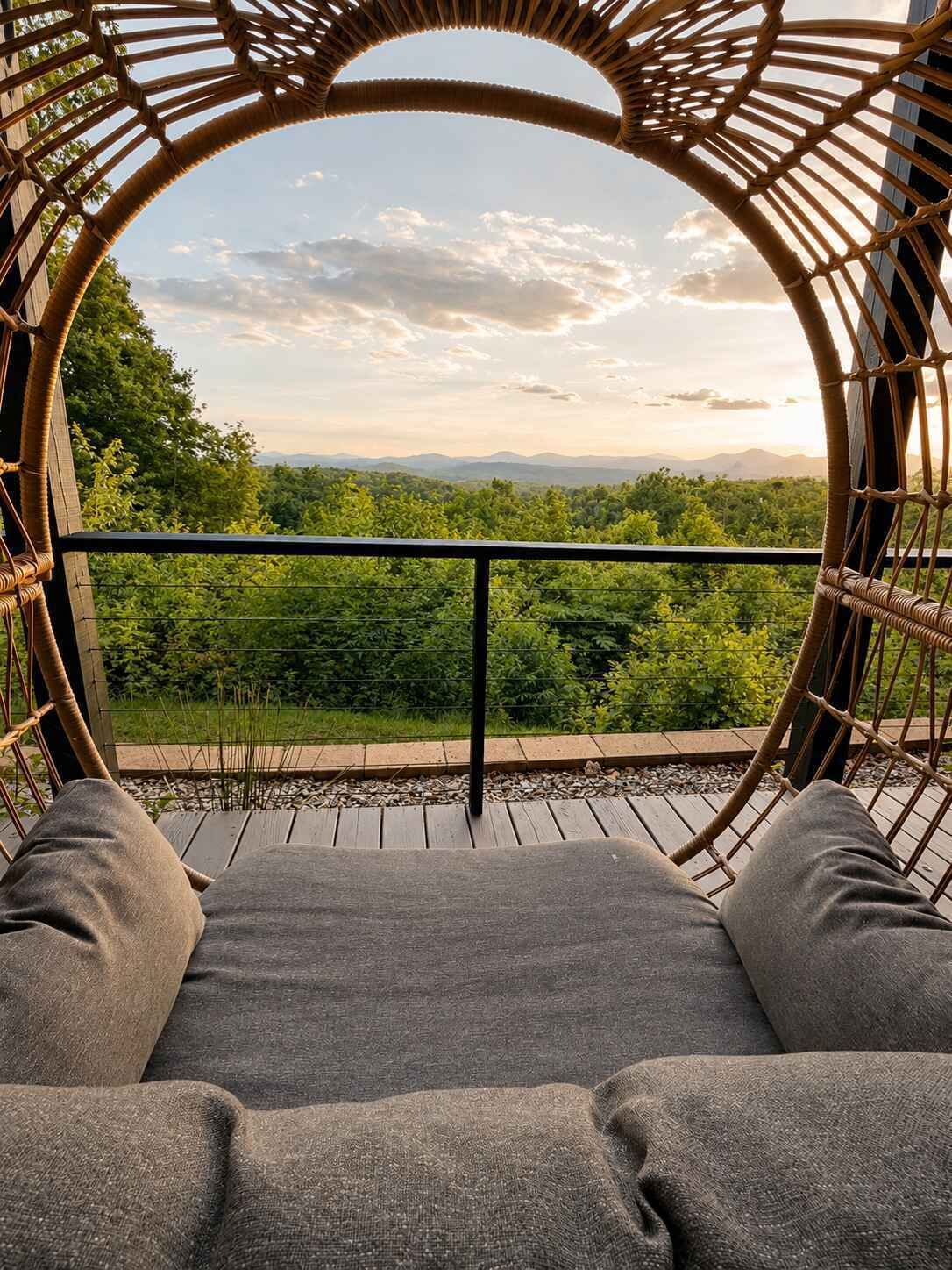 A wicker chair with a view of a lush landscape.