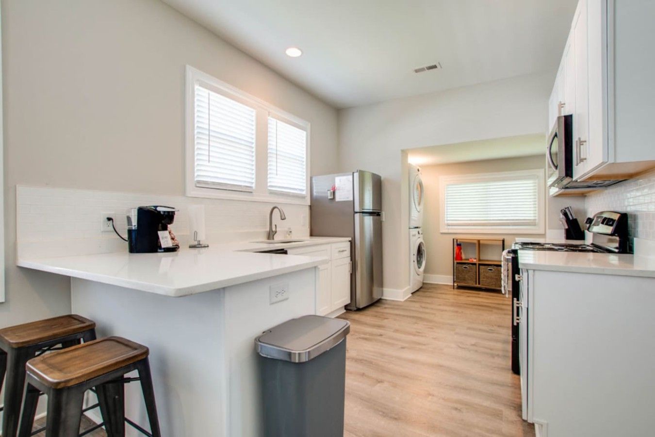 Bright Kitchen & Laundry AreaEnjoy a fully stocked kitchen with bar seating, Keurig coffee maker, and stainless appliances—plus the added convenience of in-unit washer and dryer just steps away.
