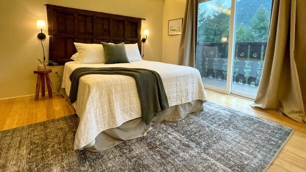 A bedroom with a bed, bedside lamps, a window with curtains, and a view of greenery outside. - #3 Hemlock Olympic Nat’l Park - Private Rm in Forest (Port Angeles)