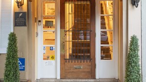 A hotel entrance with a number '1660' above the door, a bell, and a sign indicating Select Registry membership.