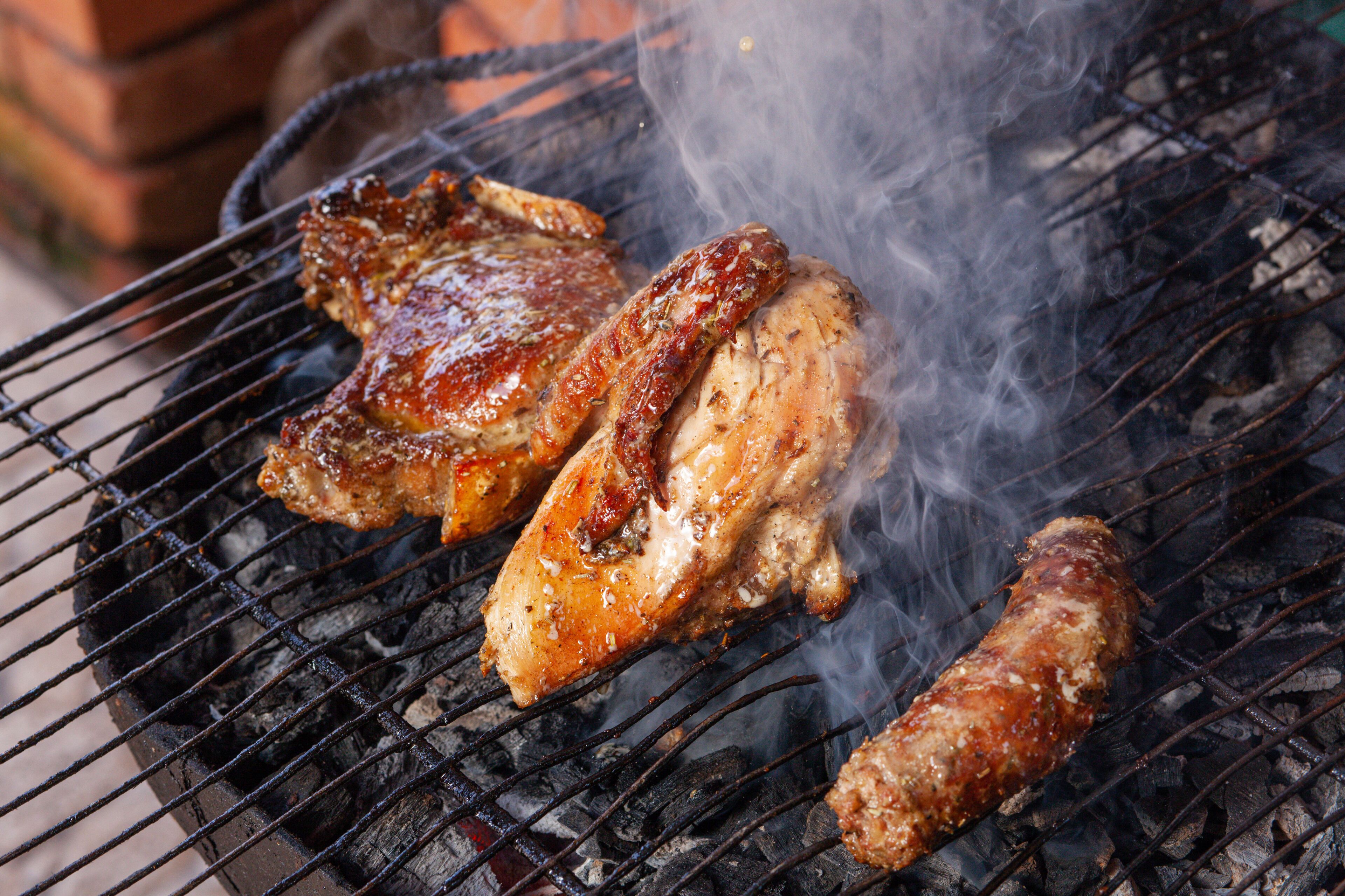 A grill with meat being cooked.