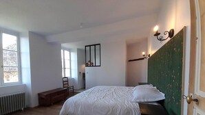 A bedroom with a bed, a chair, a desk, and a window. - Maravillon (Villon)