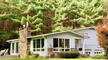 Enjoy a serene retreat in this single-story house surrounded by lush greenery and a beautifully maintained lawn.