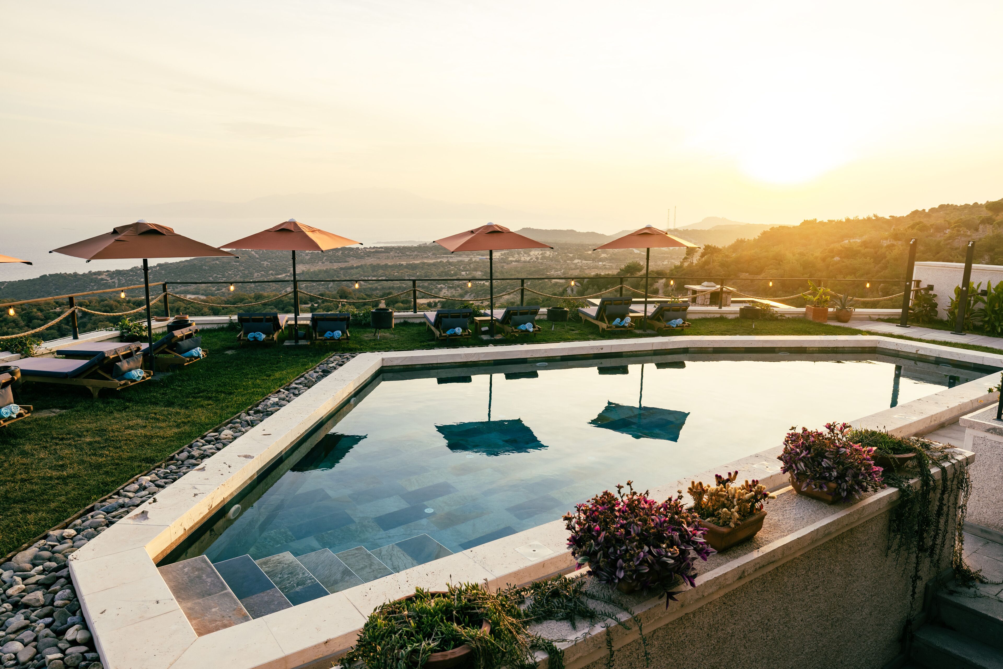 Seasonal outdoor pool, open 9:00 AM to 7:00 PM, pool umbrellas