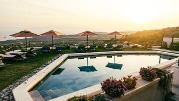 Seasonal outdoor pool, open 9:00 AM to 7:00 PM, pool umbrellas