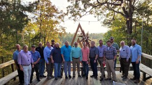 A group of people standing on a wooden deck with a wooden fence and trees in the background. - Cabin 6 - Rustic Mountain Cabin Rental - Up to 3 persons (Hatfield)