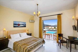 Une chambre d’hôtel avec un lit, un bureau, une chaise, un tableau et une vue sur une piscine et un paysage.
