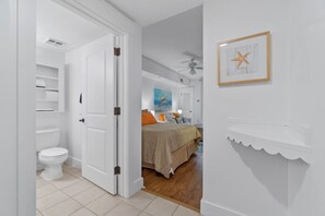 A bedroom with a bed, a nightstand, a dresser, and a framed picture on the wall. - Easy Breeze on Bay 423–Colorful–Sleeps 3 (Miramar Beach)
