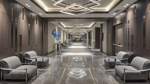 A modern hotel lobby with a long corridor, seating areas, and a reception desk. - Doubletree By Hilton Sanliurfa (Sanliurfa)