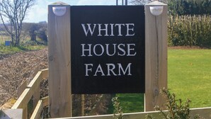 A wooden sign with "WHITE HOUSE FARM" written on it. - 3 bedroom accommodation in Knapton, near North Walsham (Knapton, near North Walsham)