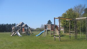 A playground with a slide and climbing structures. - 3 bedroom accommodation in Knapton, near North Walsham (Knapton, near North Walsham)