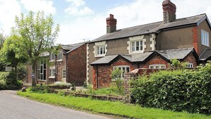 A row of traditional brick houses with pitched roofs and chimneys. - 3 bedroom accommodation in Burscough, near Southport (Burscough, near Southport)