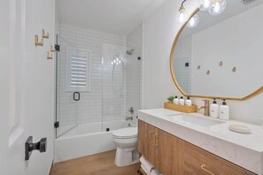 Shower, hair dryer, towels, shampoo