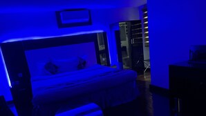 A bedroom with a bed, bedside tables, and a desk. - Novatel Hotel (Lekki)