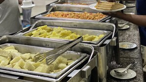 A buffet line with various food items, including fruits and a hot dish. - Novatel Hotel (Lekki)