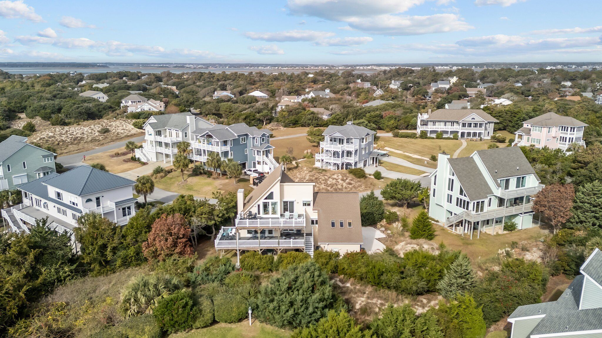 A residential area with multiple houses, some with large porches and others with attached garages.