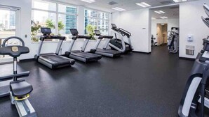 A gym with treadmills, a stationary bike, and a rowing machine. - TC-2607 · Bright and cozy 2 bedroom free parking at brickell (Miami)