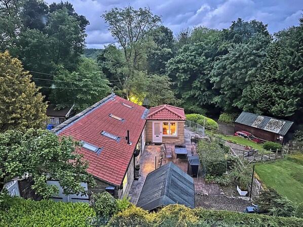 A residential area with a red-roofed house, a garage, and a small shed.