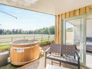 A wooden deck with a hot tub and a bench, overlooking a field. - The Tranquil Orchard - Nuthatch-UK32791 (Brocklehirst, near Dumfries)