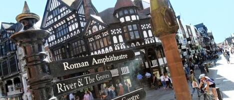 A historic building with a sign for the Roman Amphitheatre and Deva Roman Centre.