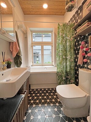 Bathtub, jetted tub, hair dryer, toilet paper