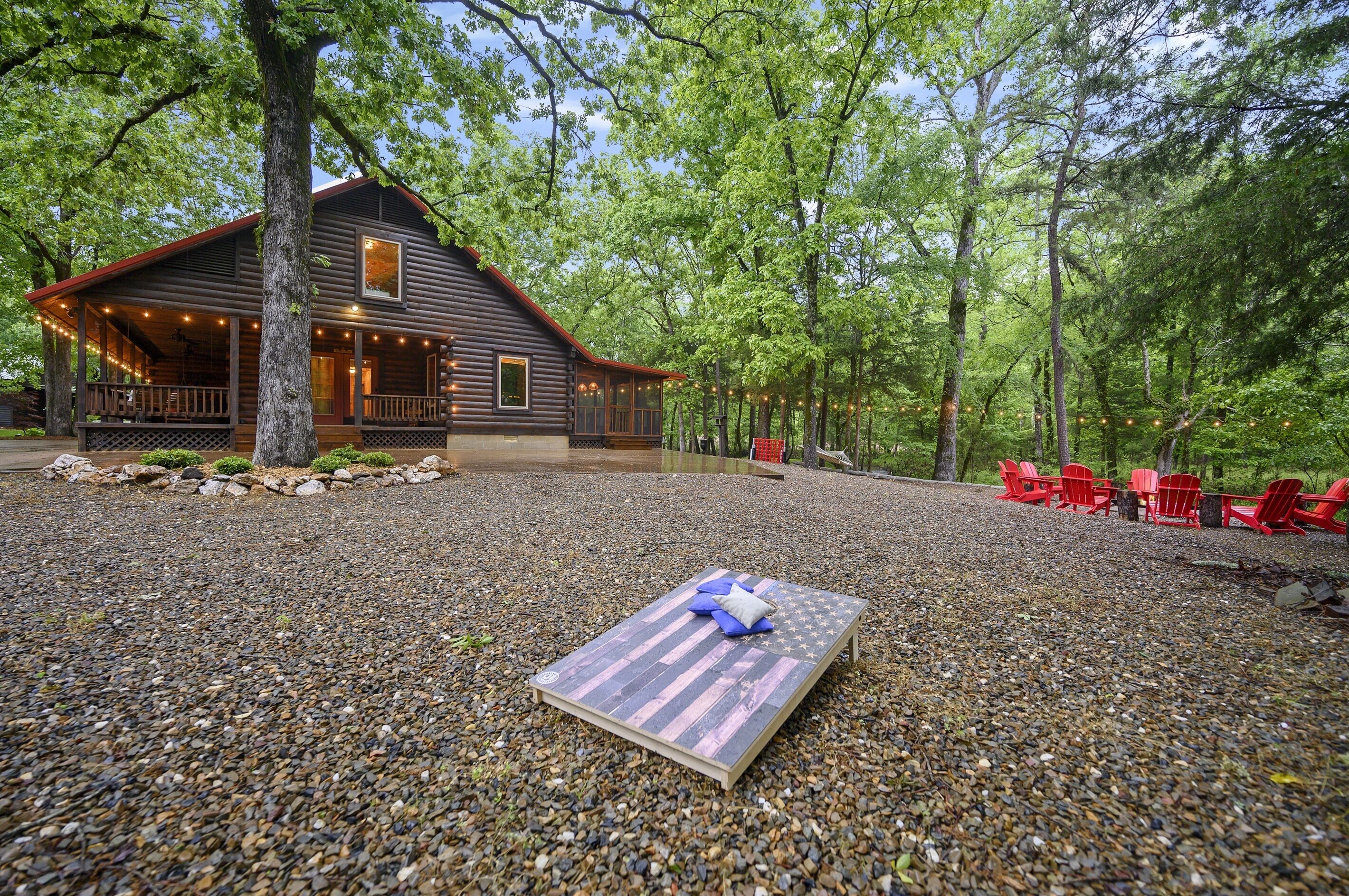 A rustic cabin with a porch and outdoor seating area.