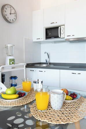 Microwave, stovetop, coffee/tea maker, cookware/dishes/utensils
