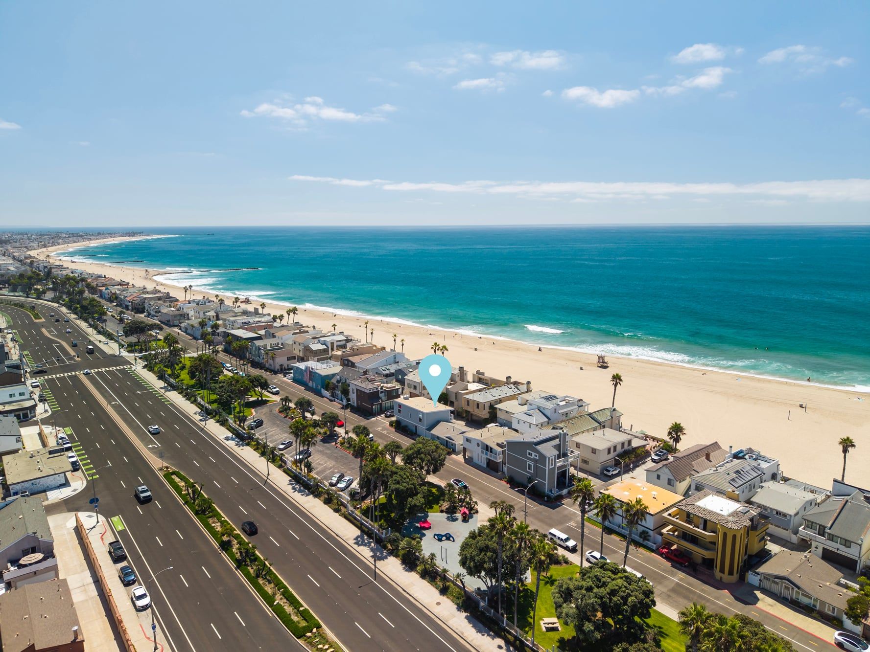 A coastal town with a beach, roads, and buildings.