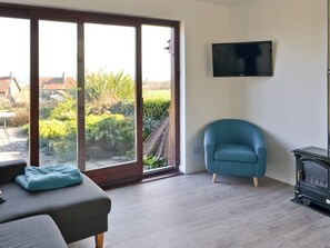 Living area - Part of a small terrace of bungalows with uninterrupted views towards the sea. (Embleton)