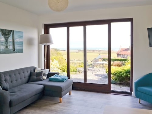Part of a small terrace of bungalows with uninterrupted views towards the sea.