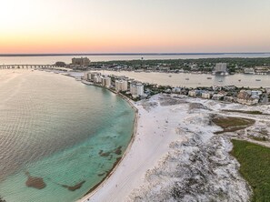 An aerial view of a coastal city with a prominent beach, marina, and a bridge connecting to the mainland. - Direct Beach Access - Top Floor Unit - Gulf Views From Complex. (Destin)