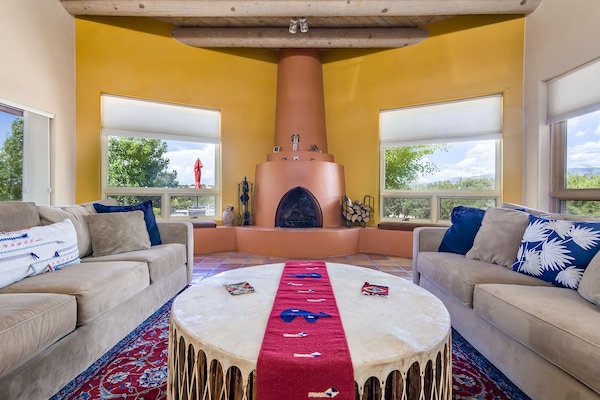 Large, comfortable living room with built-in kiva fireplace and long views.